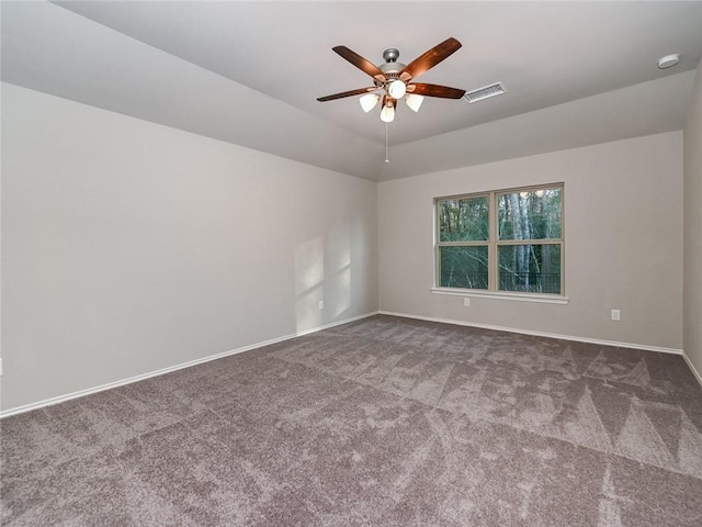 empty room featuring ceiling fan, carpet flooring, and vaulted ceiling