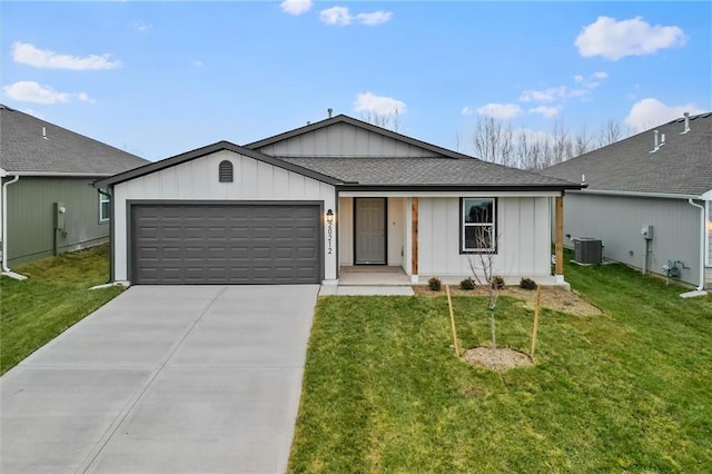 ranch-style home with a garage, cooling unit, and a front lawn