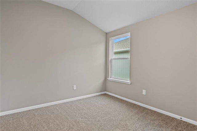 empty room featuring carpet and lofted ceiling