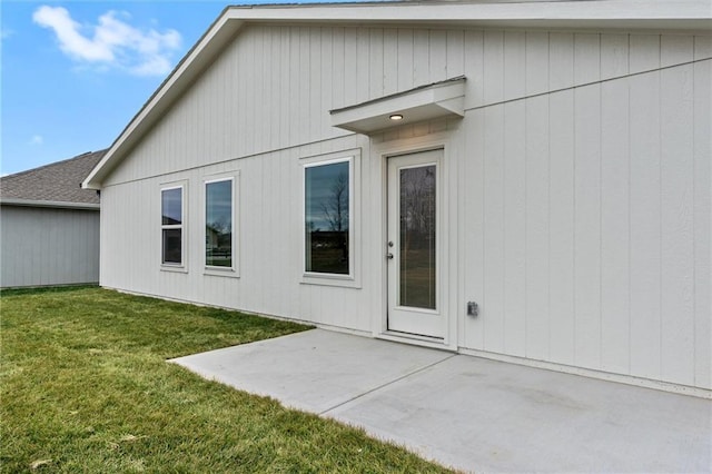 back of property with a patio area and a yard