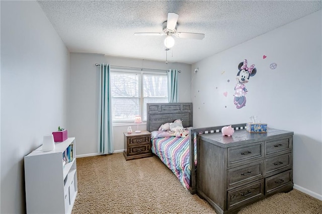 bedroom with ceiling fan, light carpet, and a textured ceiling