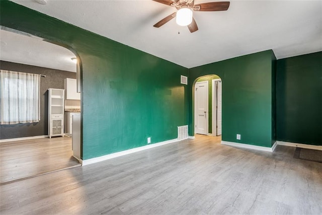 empty room with ceiling fan and light wood-type flooring