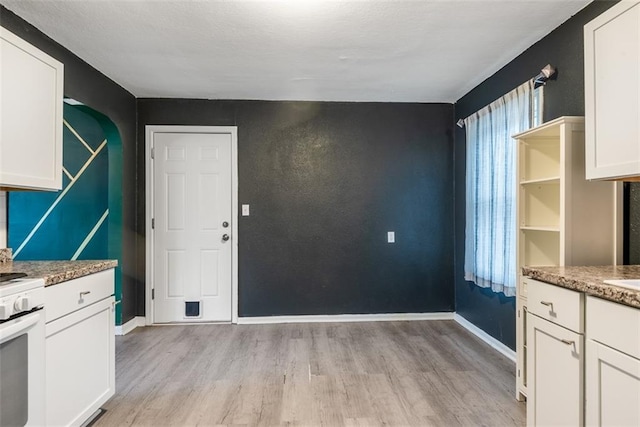 unfurnished dining area with light hardwood / wood-style flooring