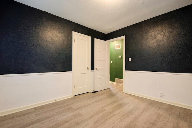 spare room with light wood-type flooring