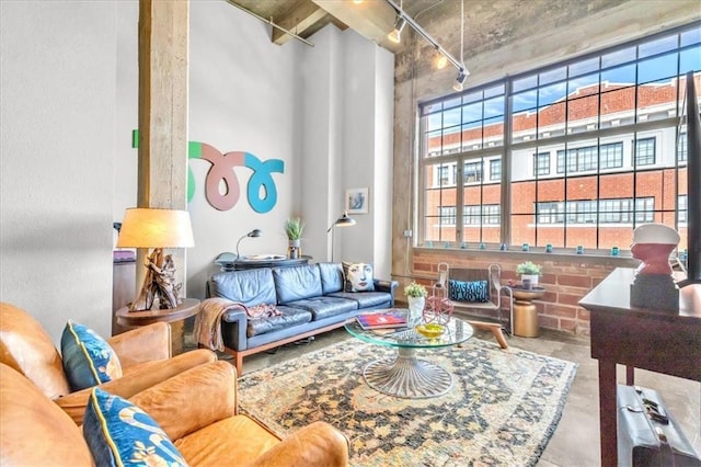 living room featuring a high ceiling and concrete floors