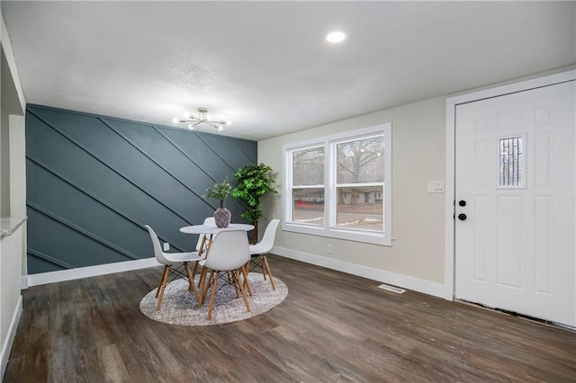 unfurnished dining area featuring dark hardwood / wood-style flooring