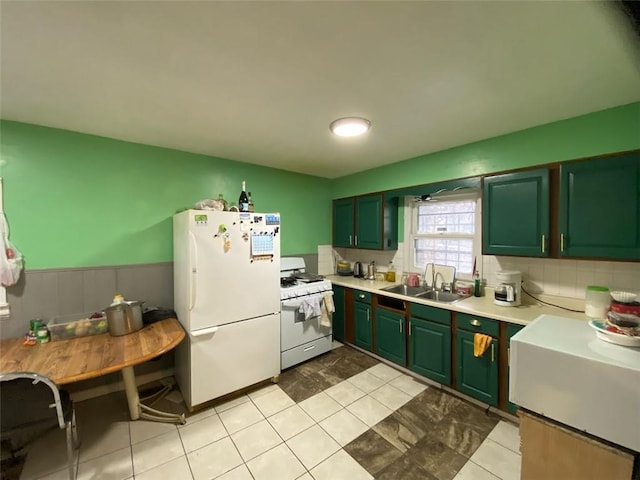 kitchen with white appliances, sink, and light tile patterned floors