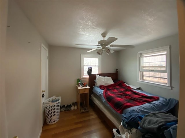 bedroom with hardwood / wood-style flooring and ceiling fan