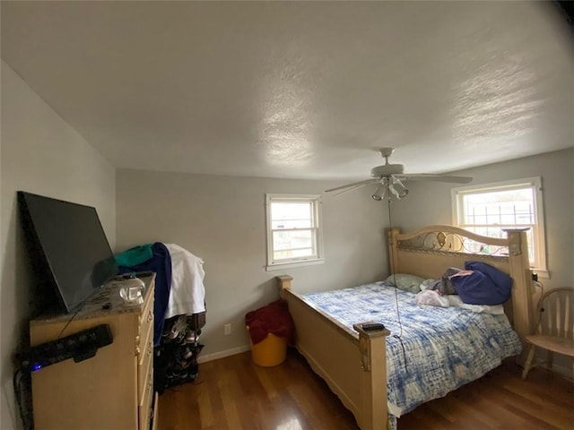 bedroom with ceiling fan, hardwood / wood-style floors, and multiple windows