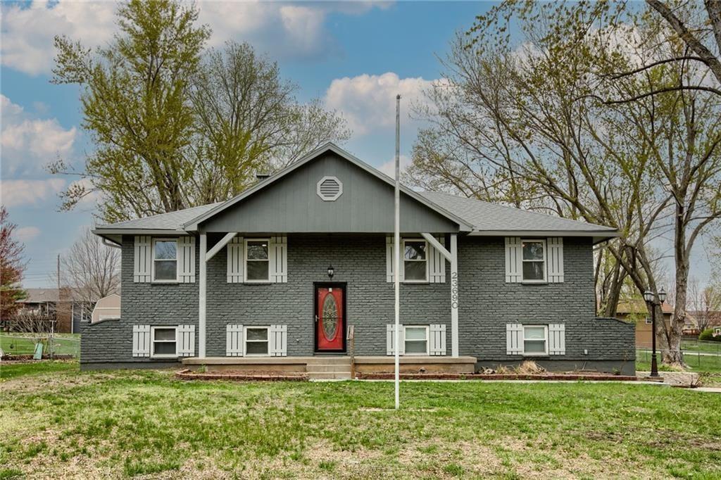 raised ranch with a front yard