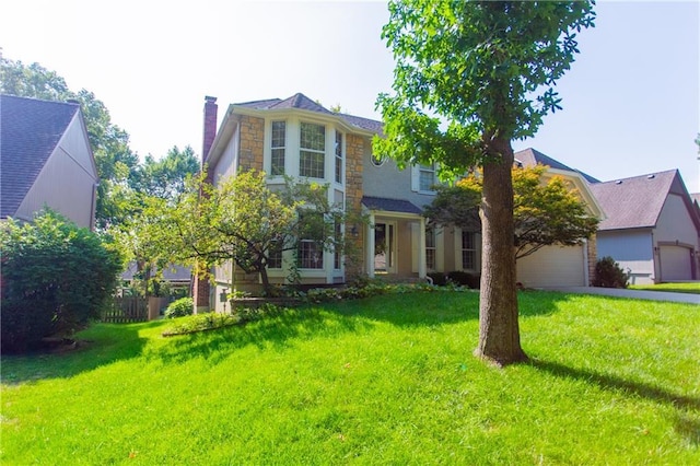 view of front of property featuring a garage and a front lawn