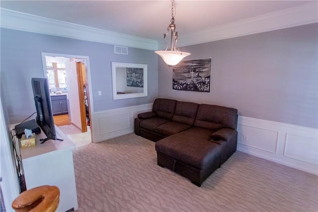 living room with light carpet and ornamental molding