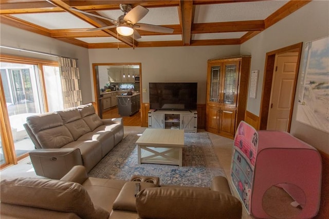 living room featuring coffered ceiling, beamed ceiling, ceiling fan, and light hardwood / wood-style flooring