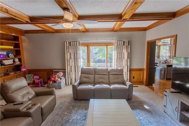 carpeted living room featuring coffered ceiling, beamed ceiling, ceiling fan, and a textured ceiling