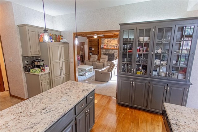 kitchen featuring light hardwood / wood-style floors, hanging light fixtures, gray cabinetry, and ceiling fan