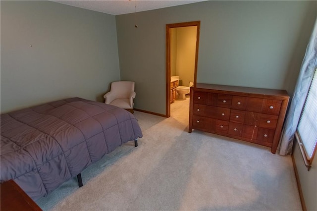 carpeted bedroom with ensuite bathroom