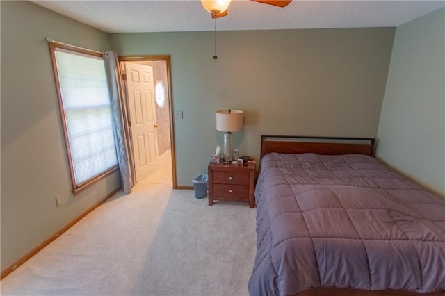 bedroom with ceiling fan and light carpet