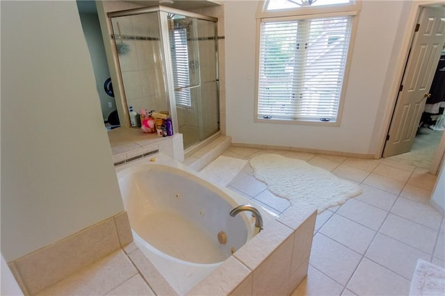 bathroom with shower with separate bathtub and tile patterned floors