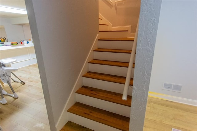 staircase featuring hardwood / wood-style flooring