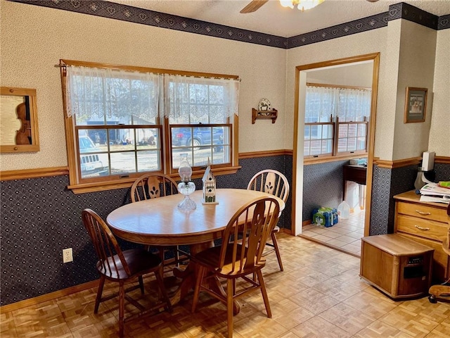 dining area featuring light parquet floors and ceiling fan