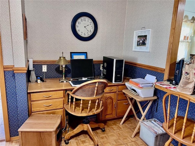 home office featuring light parquet floors and built in desk