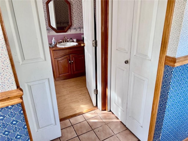 hall featuring sink and light wood-type flooring