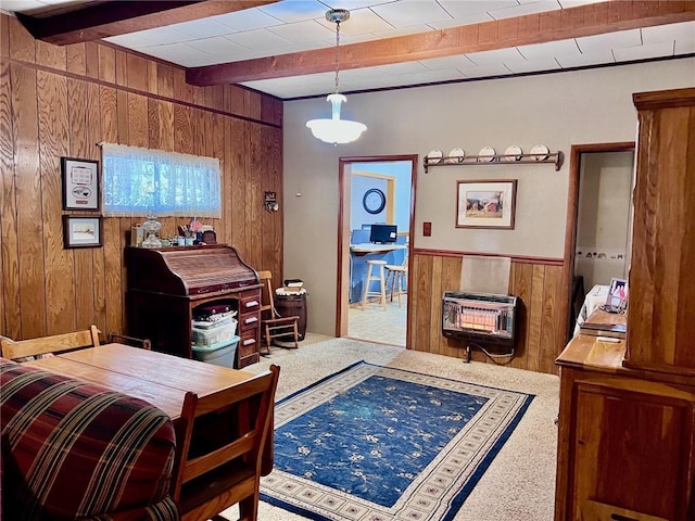 interior space with wood walls, carpet floors, heating unit, and beamed ceiling