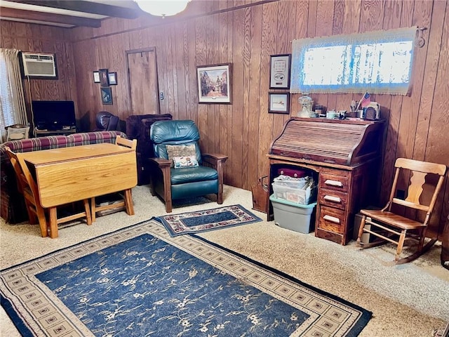 sitting room featuring wood walls, beam ceiling, and a wall mounted air conditioner