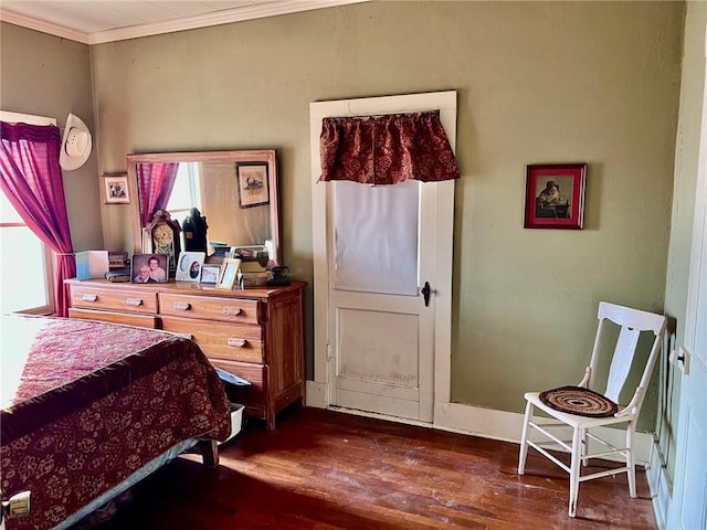 bedroom featuring ornamental molding and dark wood-type flooring