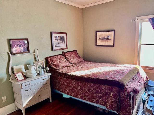 bedroom featuring crown molding and dark hardwood / wood-style floors