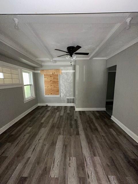 3920 S Benton Ave, Kansas City, MO 64130 - spare room with dark wood-style floors, beam ceiling, baseboards, crown molding, and a ceiling fan