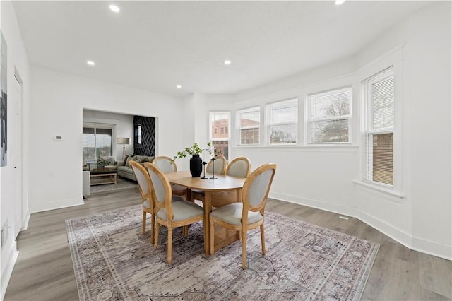 dining space with a healthy amount of sunlight, light wood-style floors, and recessed lighting