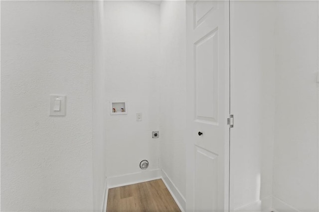 laundry room featuring hookup for a washing machine, electric dryer hookup, wood finished floors, laundry area, and baseboards