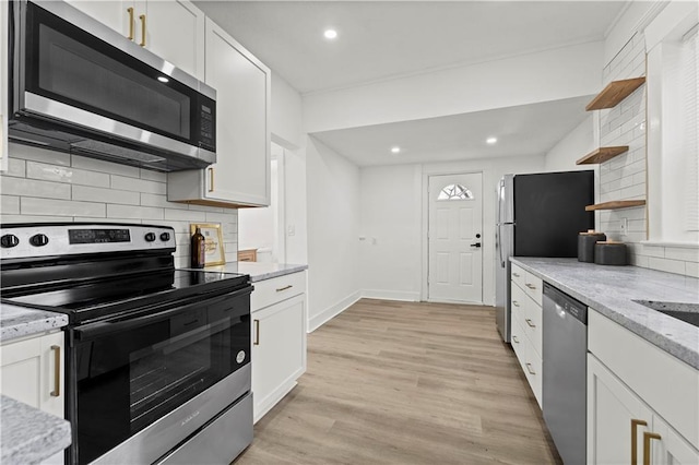 kitchen with stainless steel appliances, white cabinets, and open shelves