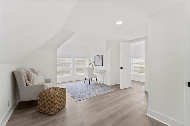 sitting room with recessed lighting, vaulted ceiling, baseboards, and wood finished floors