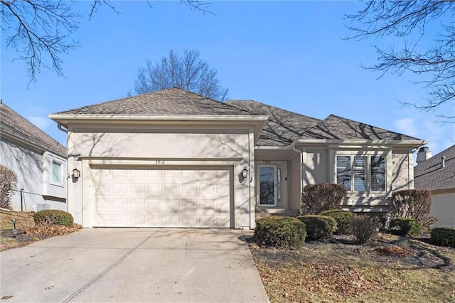 view of front of house featuring a garage, concrete driveway, and stucco siding