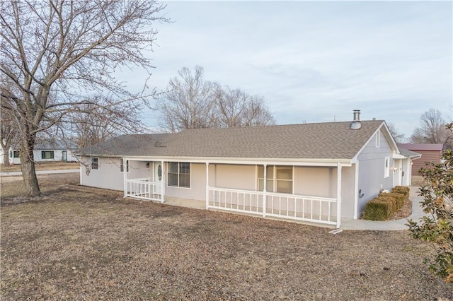 ranch-style home with covered porch and a front yard