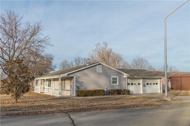 ranch-style house with a garage and covered porch