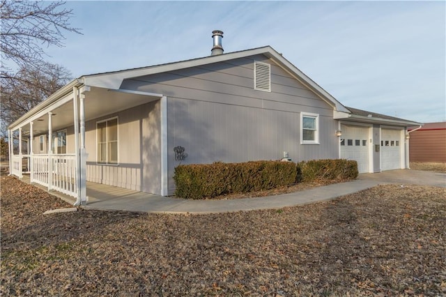 view of property exterior featuring a porch and a garage