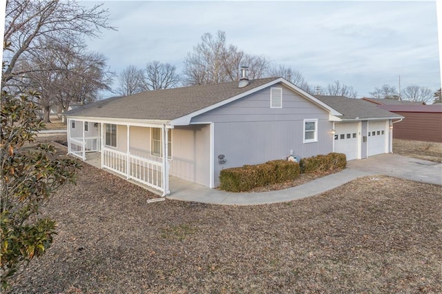 view of side of property featuring a porch and a garage