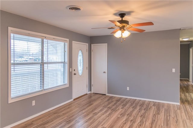 foyer entrance with wood-type flooring and ceiling fan