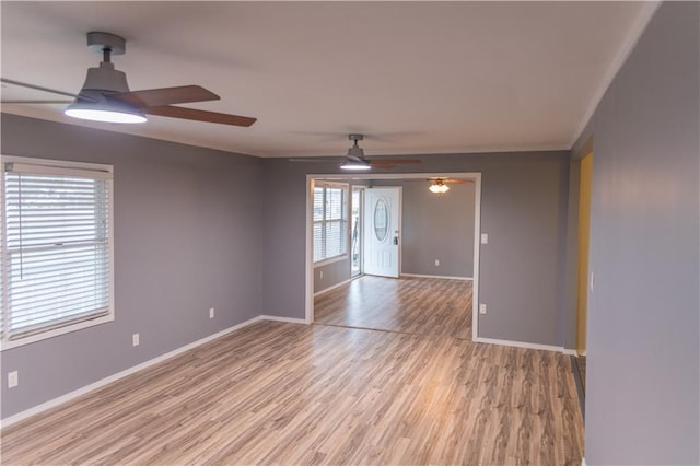 unfurnished room with crown molding, ceiling fan, and light wood-type flooring