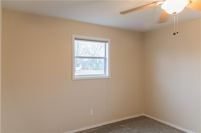 unfurnished room with ceiling fan and carpet