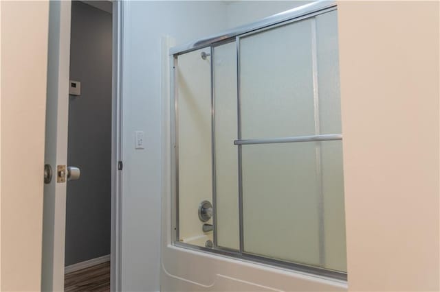 bathroom featuring shower / bath combination with glass door