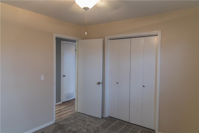 unfurnished bedroom with carpet and a closet