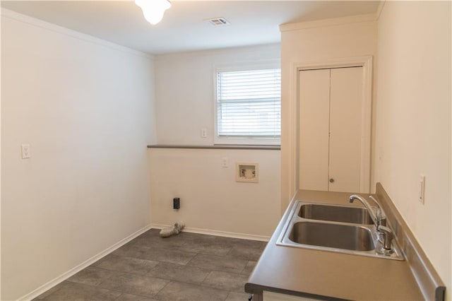 clothes washing area featuring ornamental molding, sink, and washer hookup