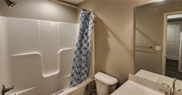 full bathroom featuring toilet, vanity, and shower / bathtub combination with curtain