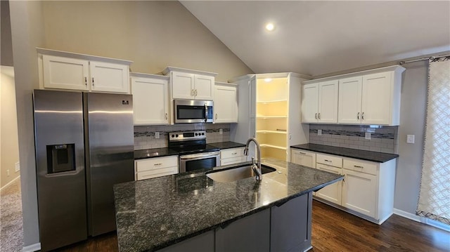 kitchen featuring sink, dark hardwood / wood-style flooring, stainless steel appliances, a kitchen island with sink, and white cabinets