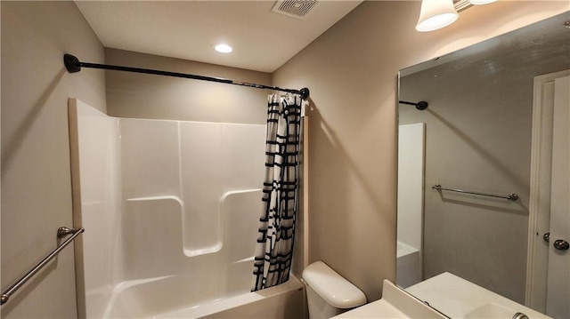 bathroom with shower / tub combo with curtain and toilet