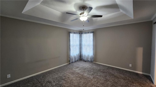 unfurnished room featuring crown molding, a tray ceiling, ceiling fan, and carpet